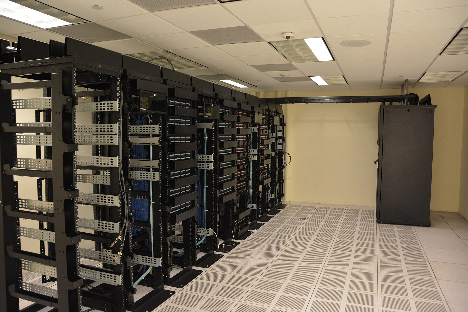 Rows of server cabinets inside a real data center.